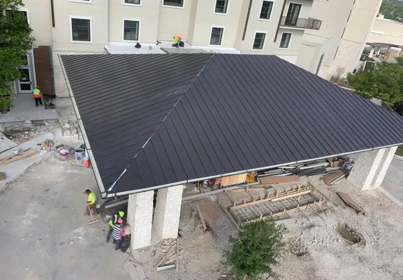 Metal roofing installation team working on a commercial building in Seattle