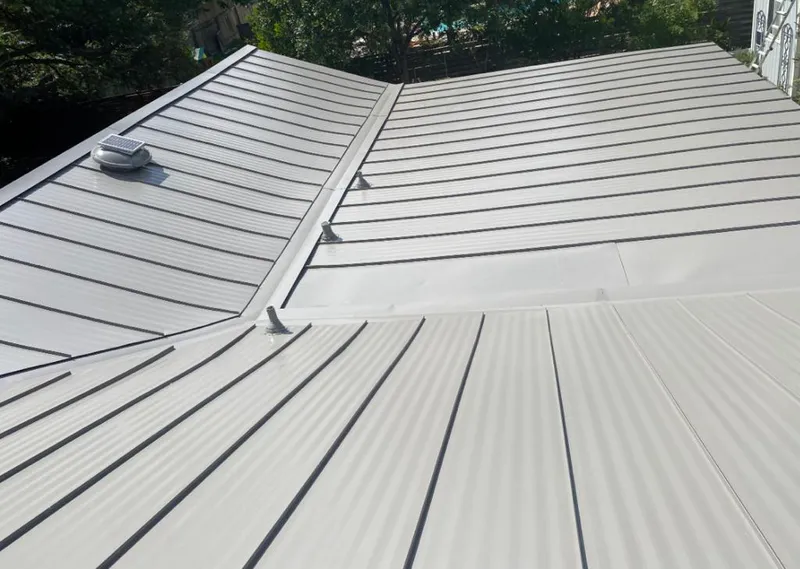 Solar attic fan installed on a metal roof for Roof Ventilation in Seattle